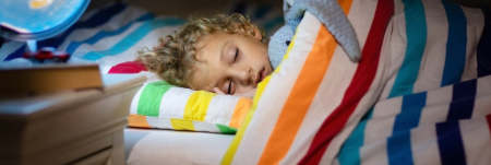 A child sleeping in bed.