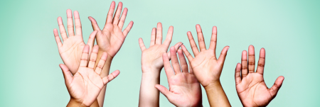 Multiple hands raised in the air
