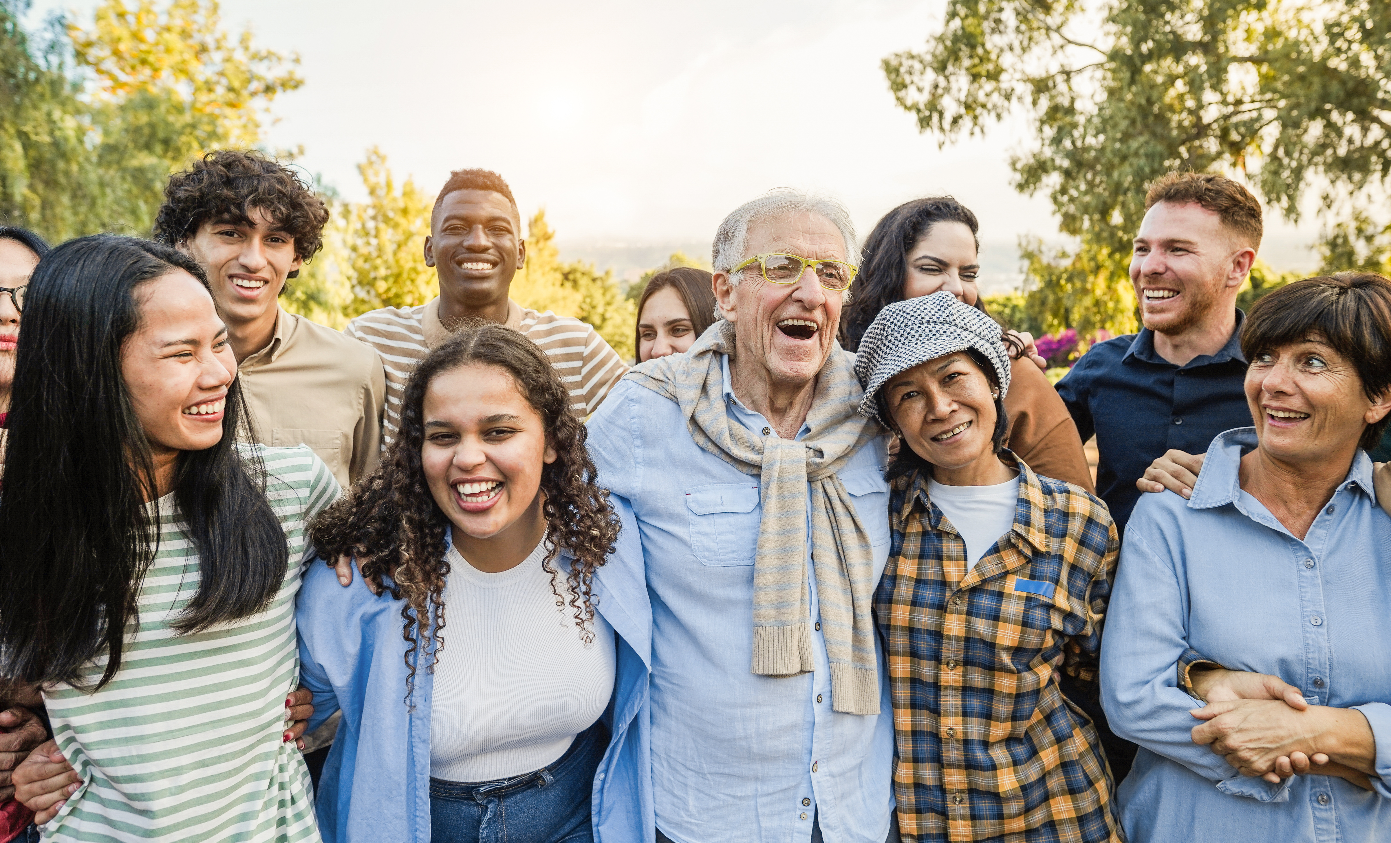 Group of multigenerational people smiling in front of camera - M